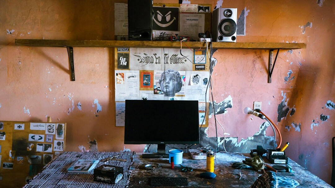 Overhead view of a workshop table with notebooks, microphone and laptop